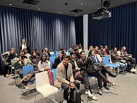 Students on the Master's programme in International Management sit in a presentation room at Airbus and listen to an introduction to aircraft production.