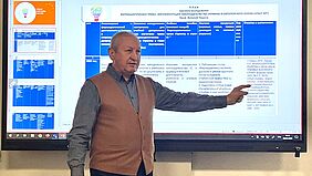 Ein ukrainischer Kollege präsentiert vor einem Bildschirm die Ergebnisse seiner Forschungsarbeit