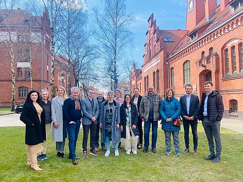 A group photo of the project participants in front of a historic building in Klaipedia, Lithuania.